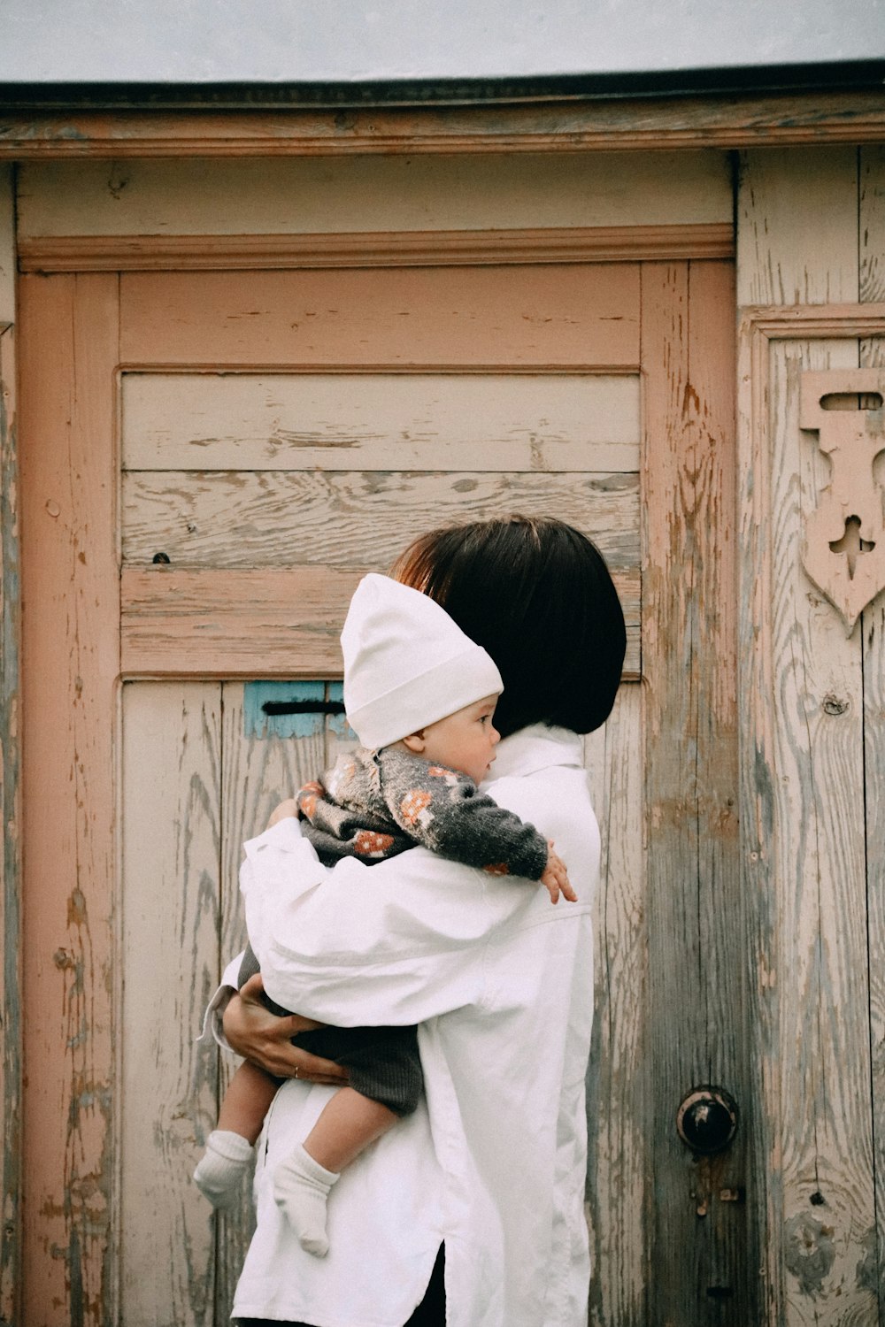 a woman holding a small child in her arms