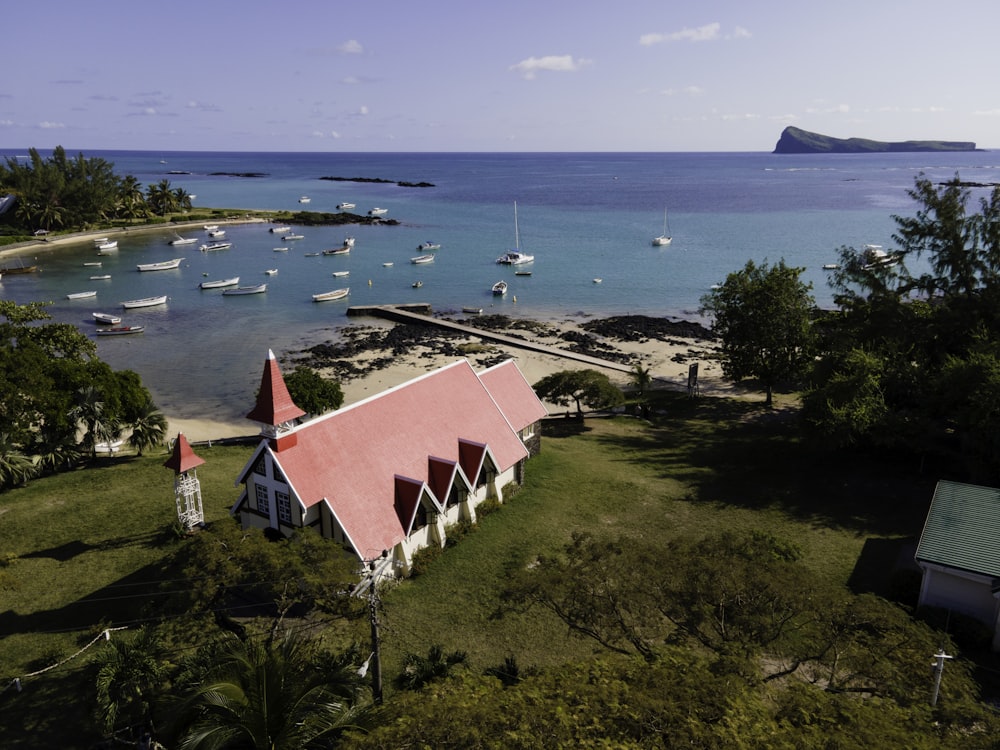 an aerial view of a small church on the shore