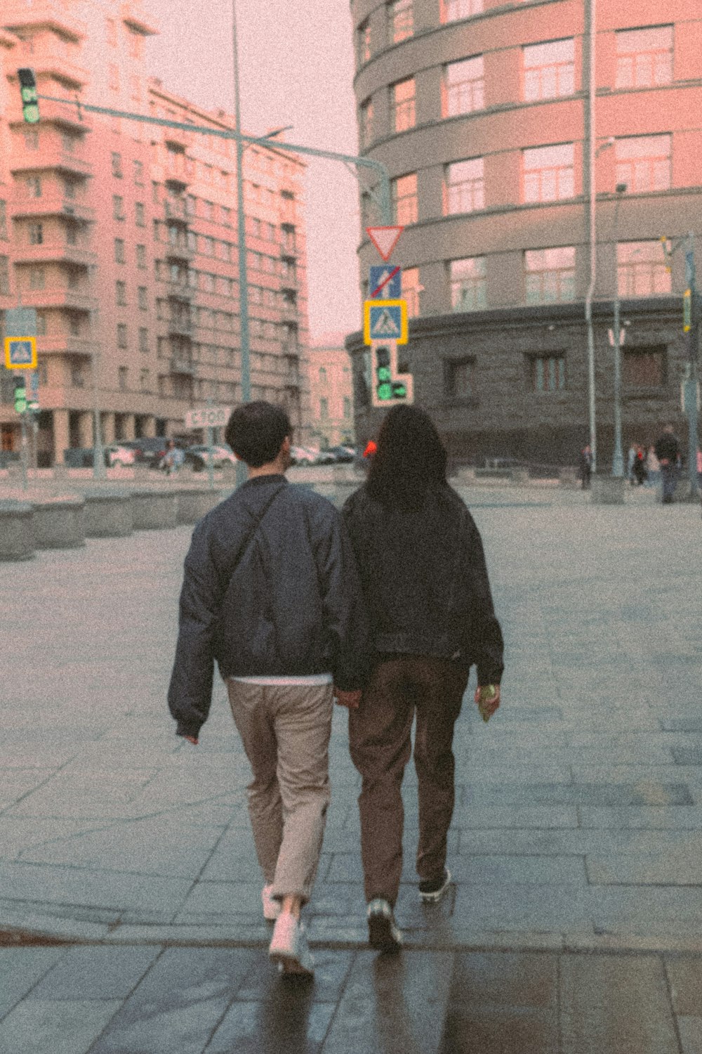 a couple of people walking down a street