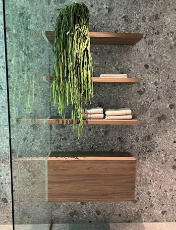 Stylish bathroom with water-resistant wooden shelves and accessories.