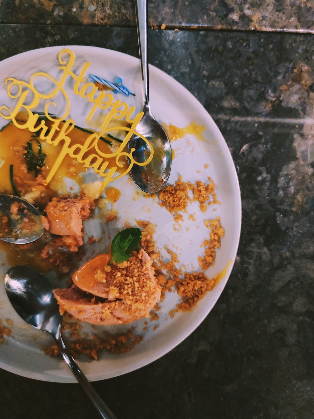 a white plate topped with food and a spoon