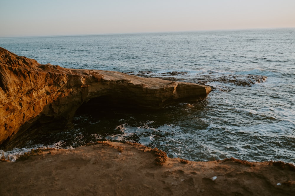 a large rock sticking out of the ocean