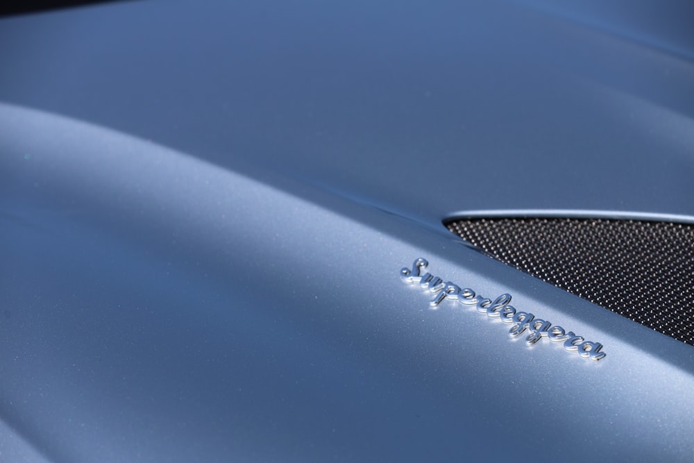 a close up of the hood of a blue sports car