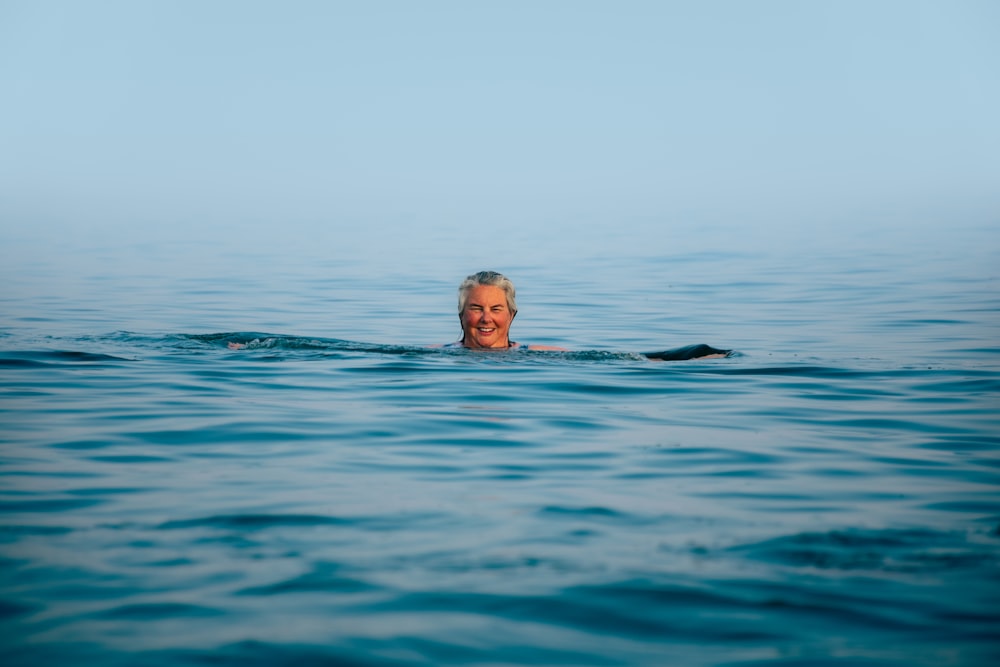 a man swimming in the middle of the ocean