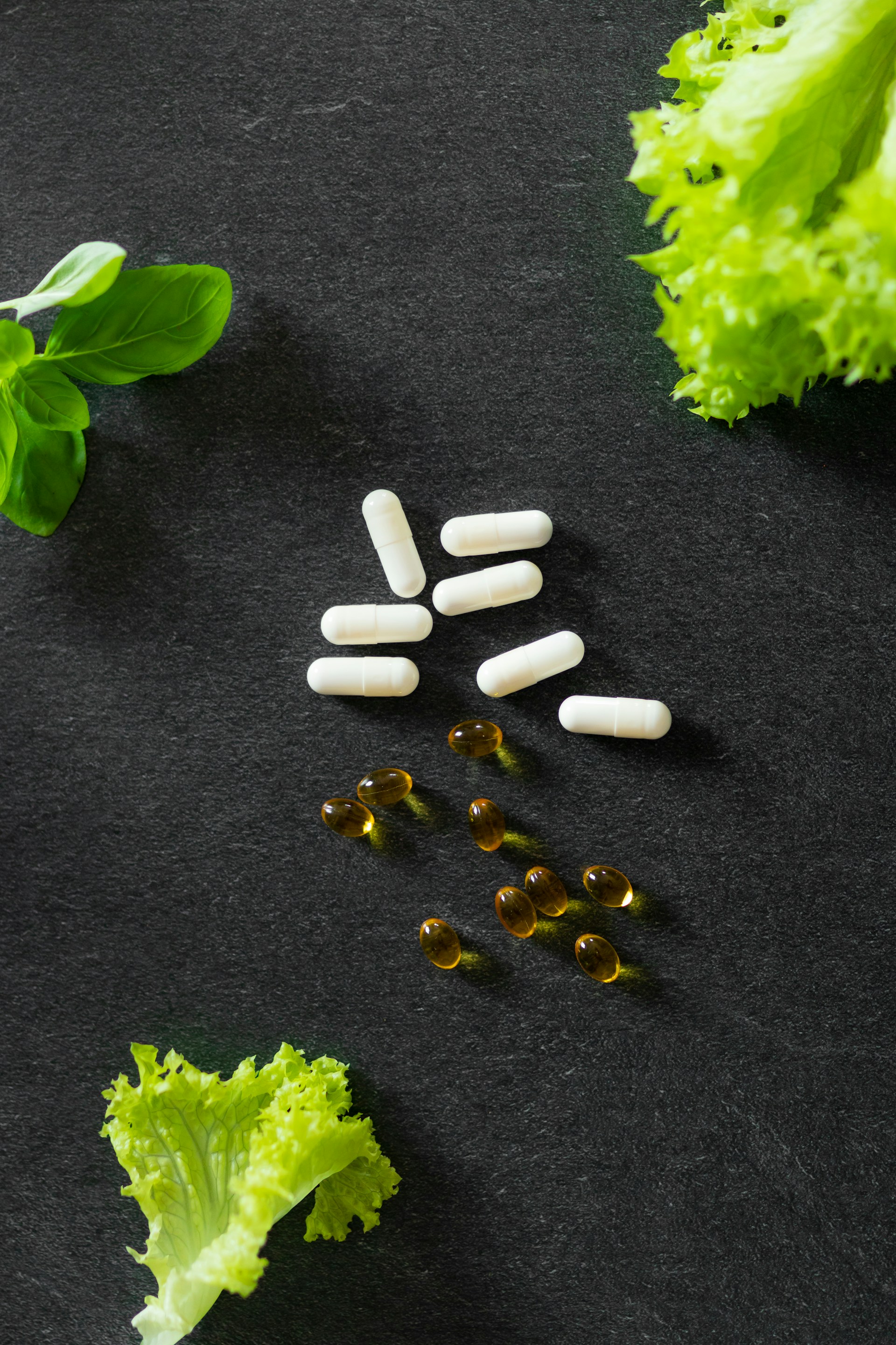 a bunch of pills sitting on top of lettuce