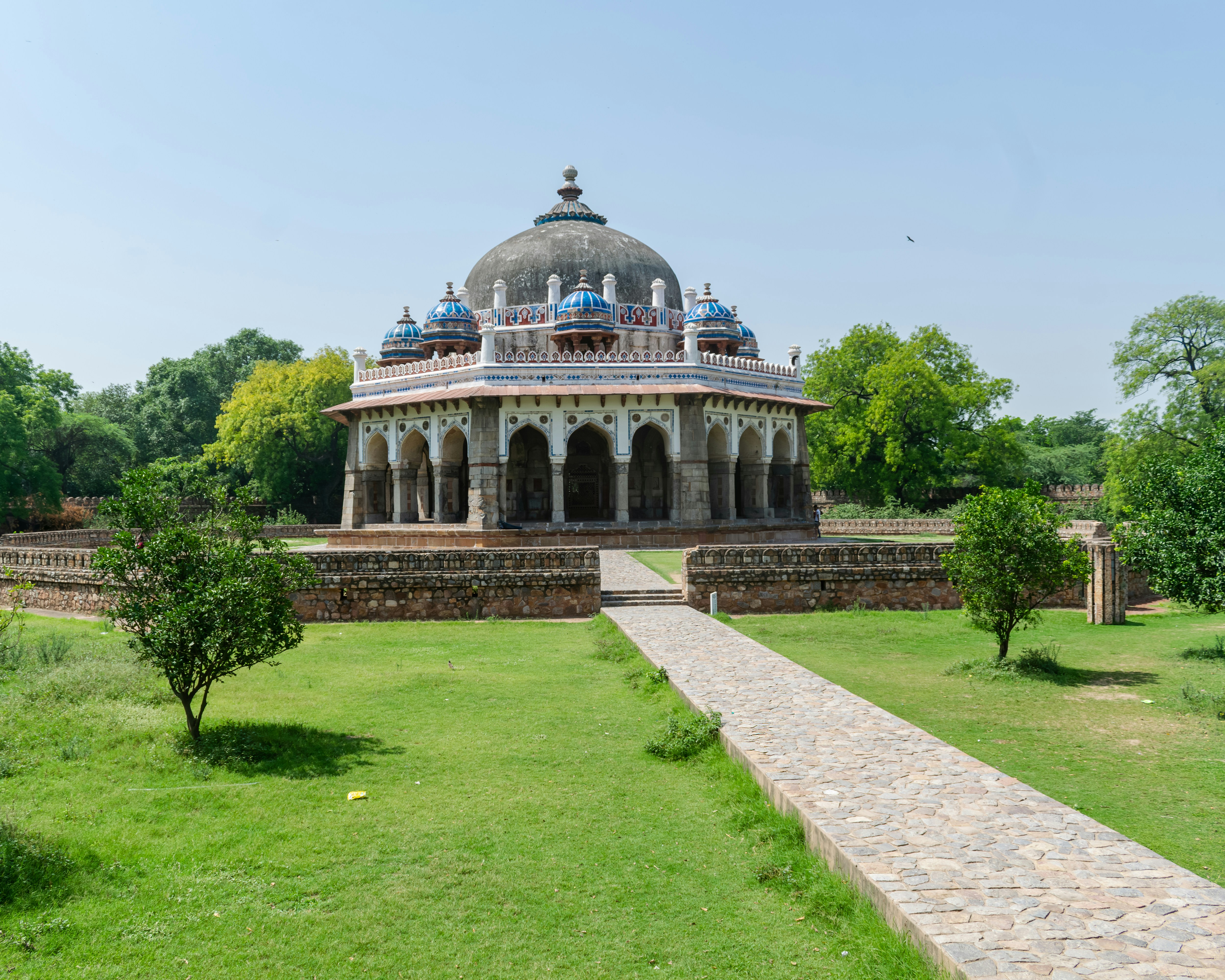 a building in a park with a walkway leading to it