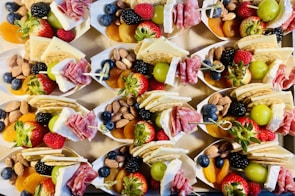A rustic wooden tray filled with assorted homemade snacks, showcasing their natural textures and colors.