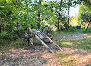 A vibrant photo of a classic wooden soapbox cart racing down a hill on a sunny day.