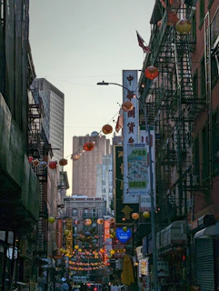 A bustling street scene where Eastern lanterns hang alongside Western-style cafes.