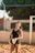 a woman holding a volleyball on a beach