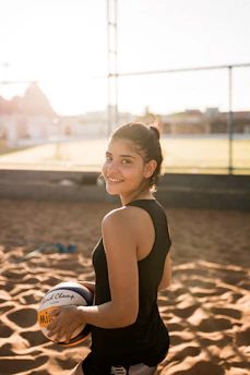 Young volleyball players practicing drills on an outdoor court under sunny skies.