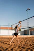 a woman reaching up to catch a ball