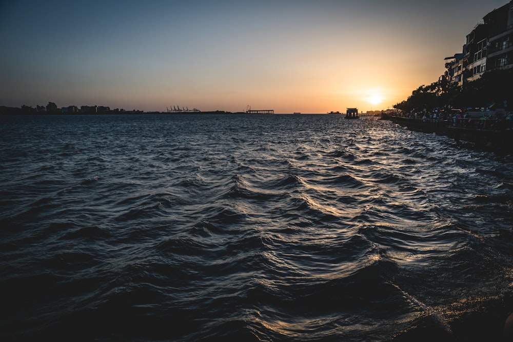 the sun is setting over a body of water