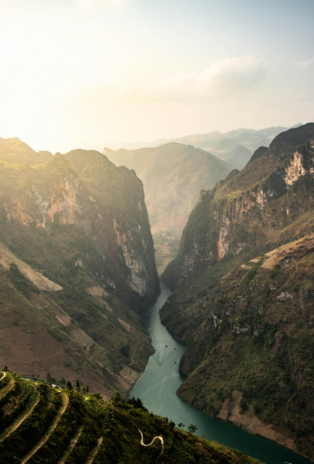 a river in a valley surrounded by mountains