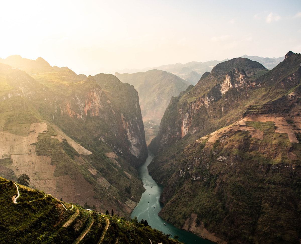 This is the summit of the drive: Mã Pí Lèng Pass, one of Vietnam's Great Passes, where the road clings to the cliff edge above the emerald ribbon of the Nho Quế River far below.