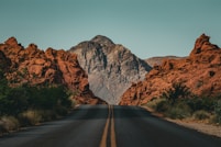 a road with a mountain in the background