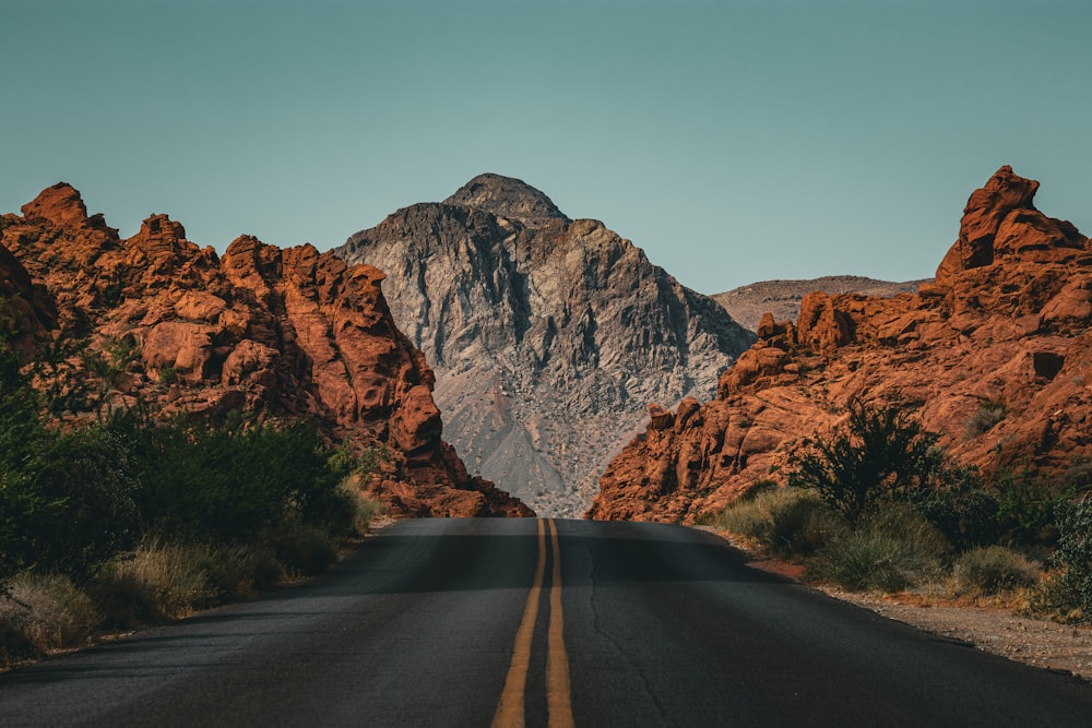 a road with a mountain in the background