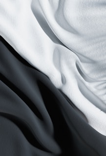 Close-up black and white print of textured fabric draped elegantly.