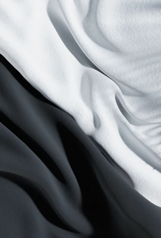 Close-up of a high-quality fabric print featuring abstract digital art patterns in monochrome tones.