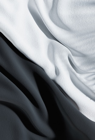 Close-up black and white print of textured fabric draped elegantly.