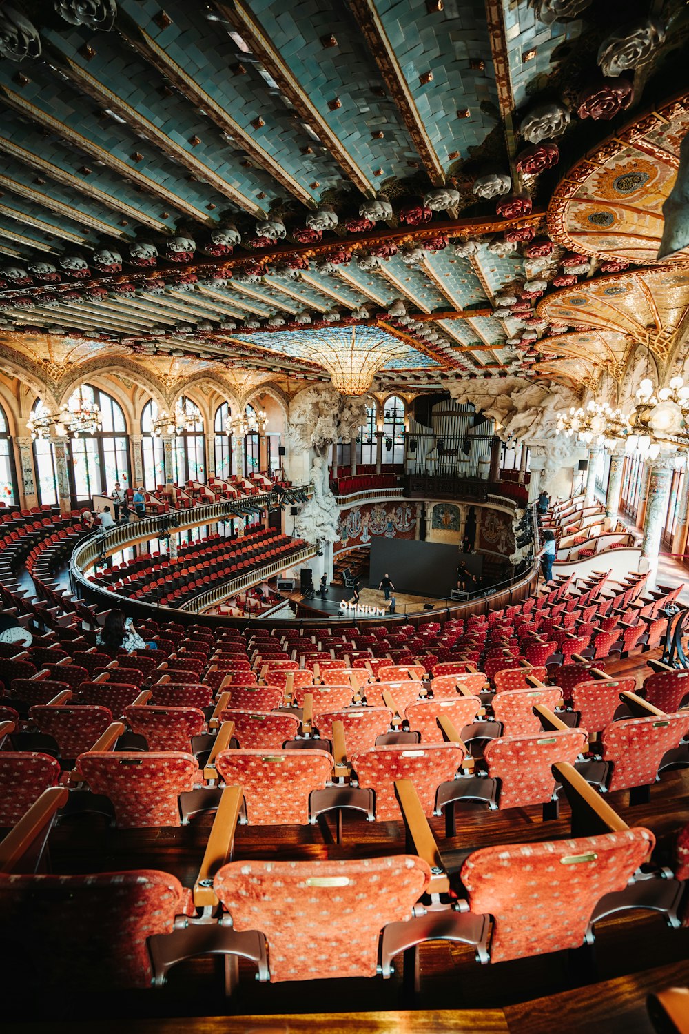 a large auditorium with rows of red seats