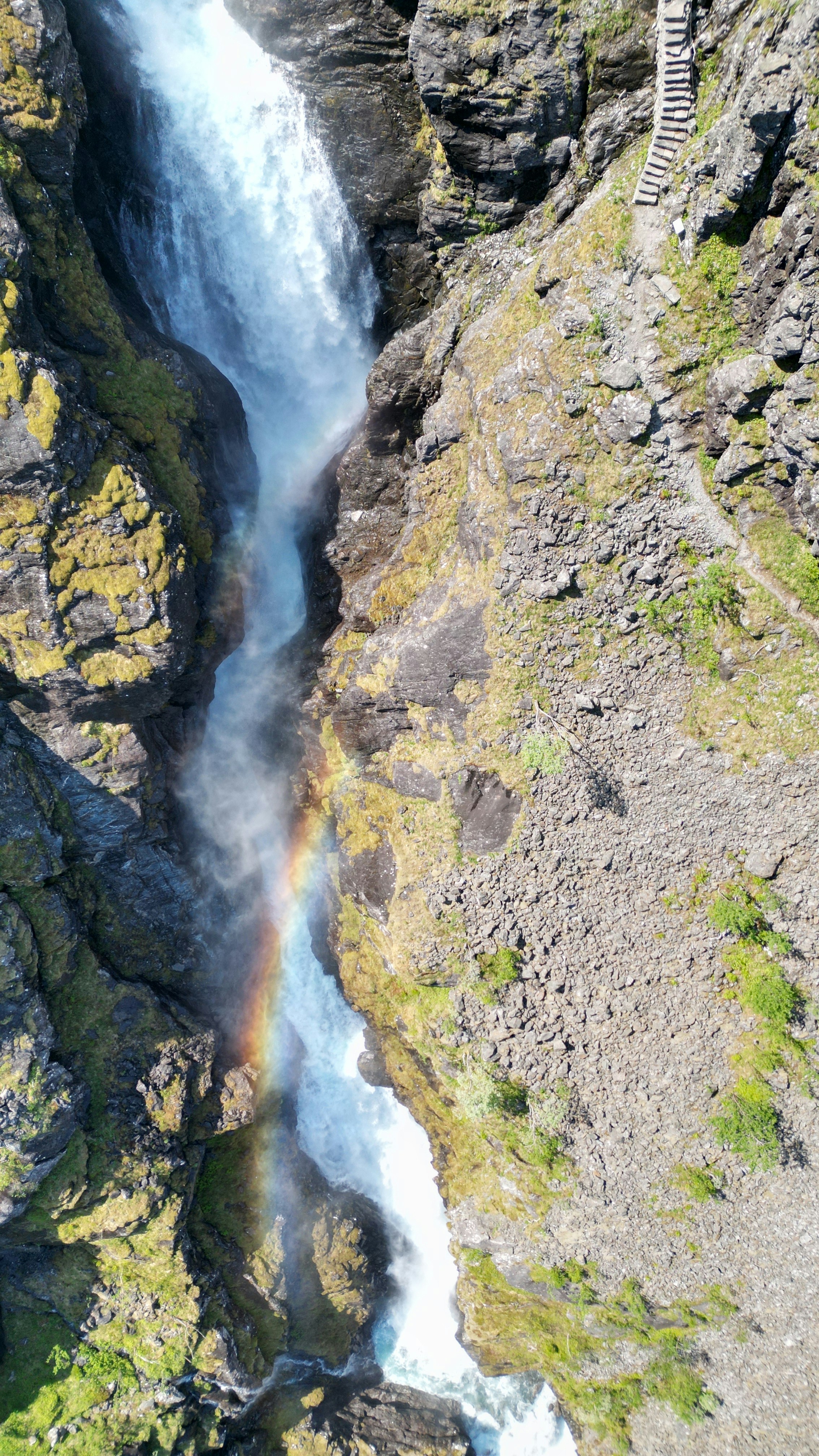 a waterfall with a rainbow in the middle of it