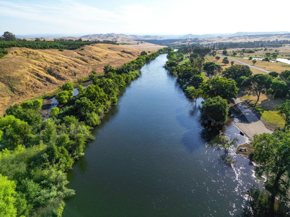 a river running through a lush green countryside