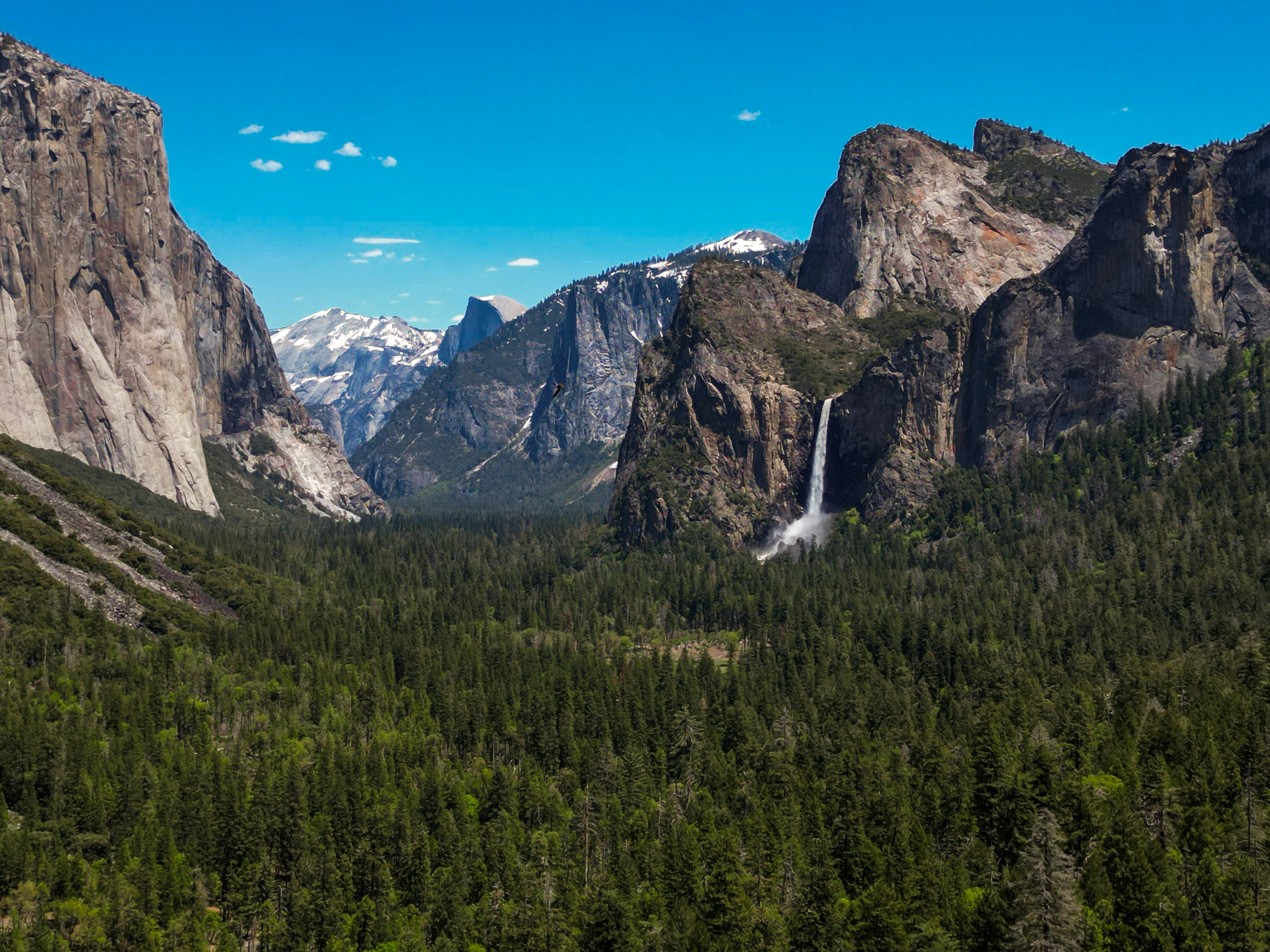 a view of a waterfall in the middle of a forest, Yosemite National Park Tunnel View Aerial Photo