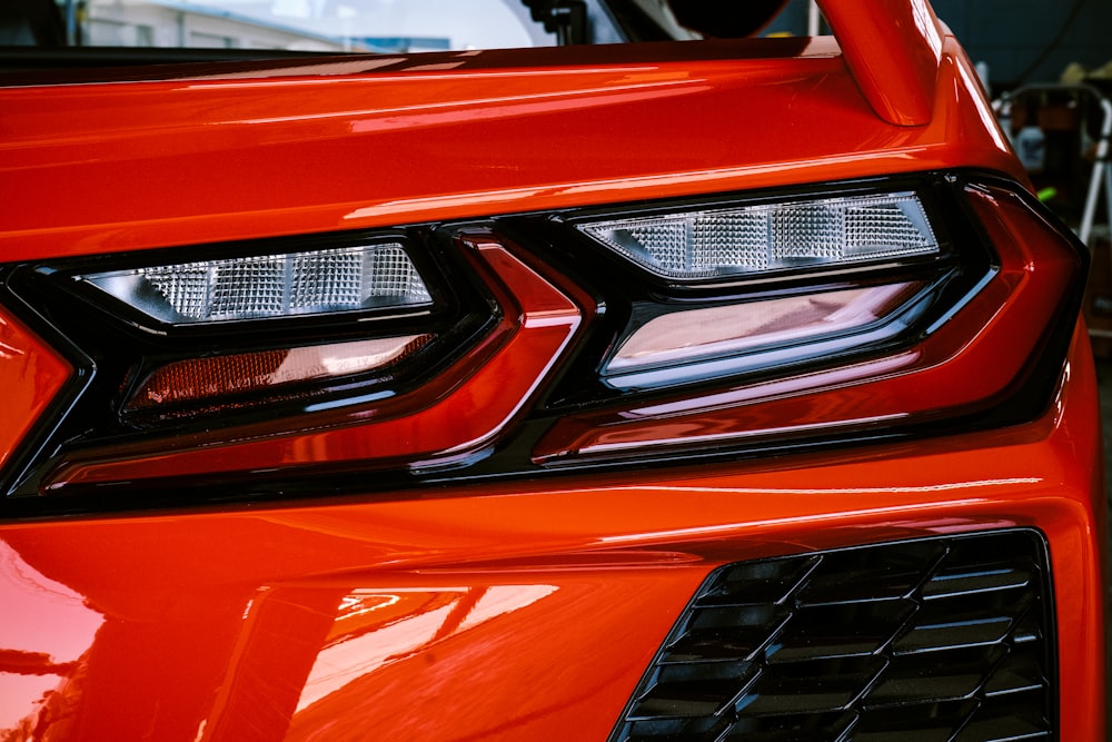 a close up of the front of a red sports car