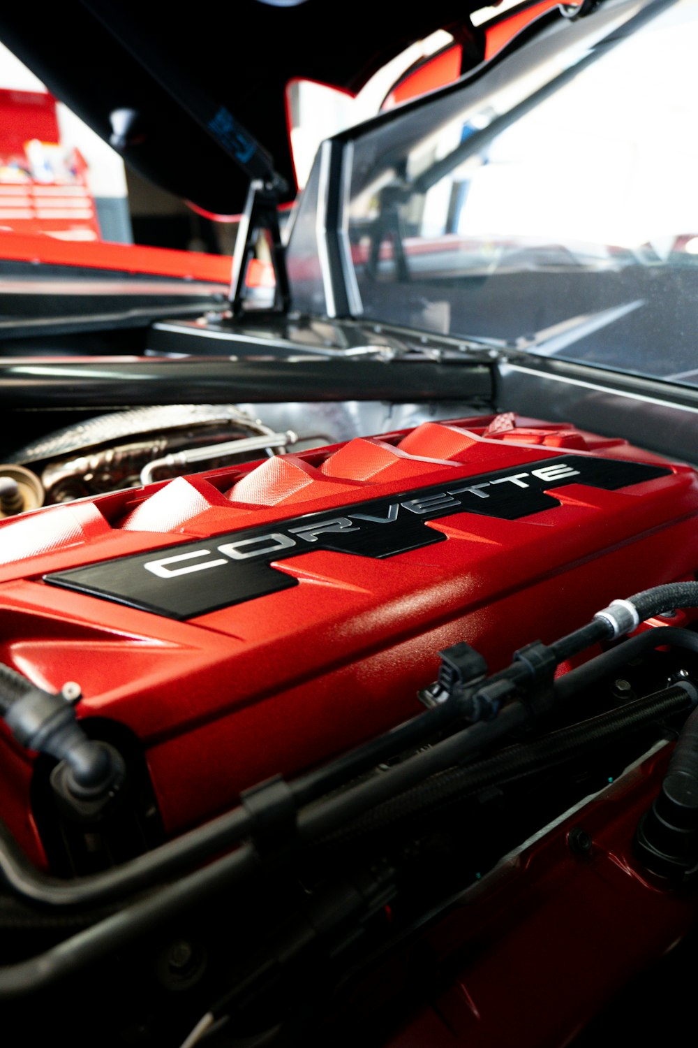 a red car engine with its hood open
