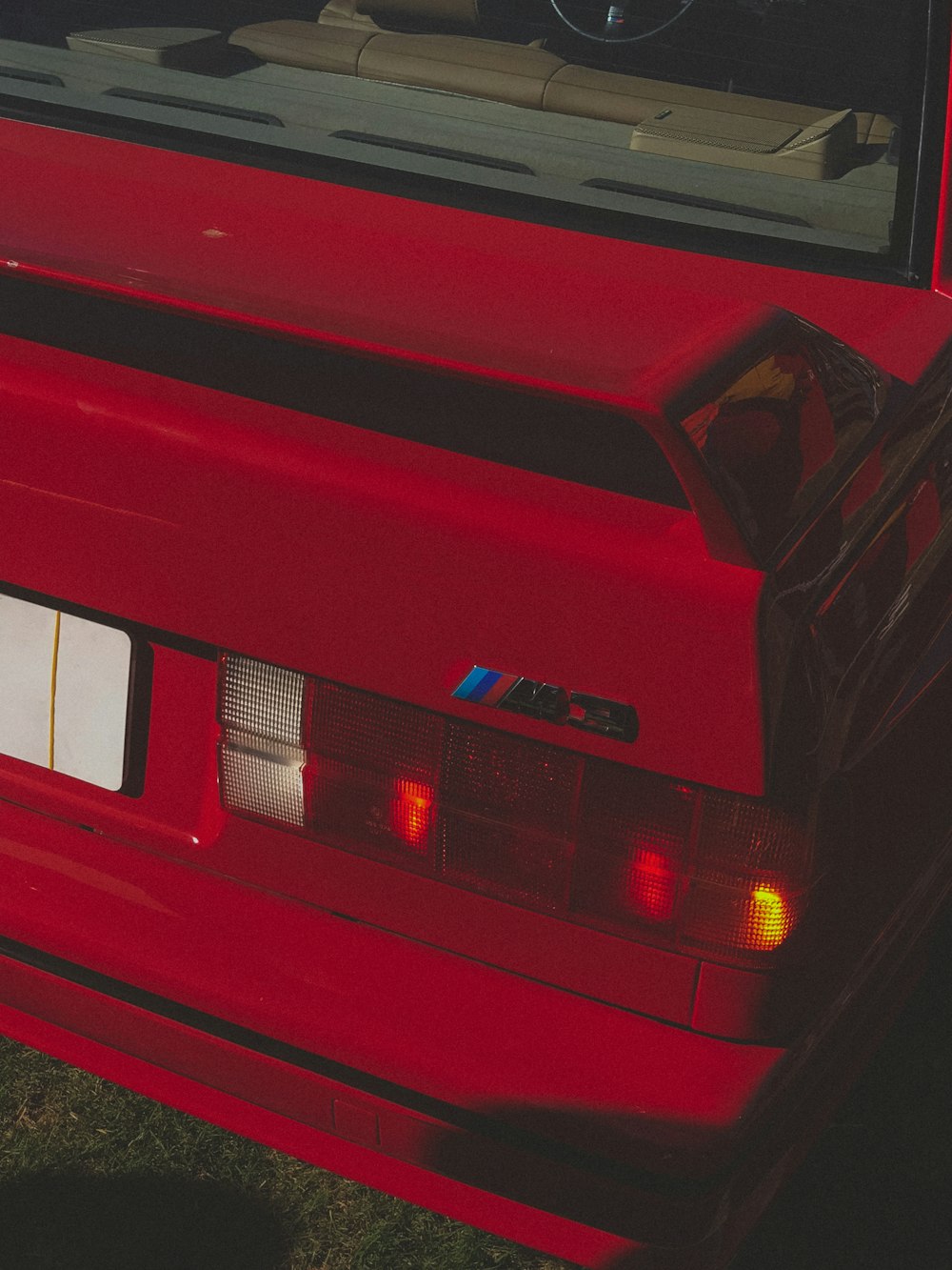 a red car is parked on the grass