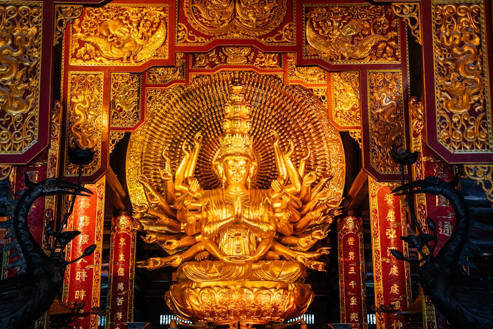 a golden statue of a buddha in a temple
