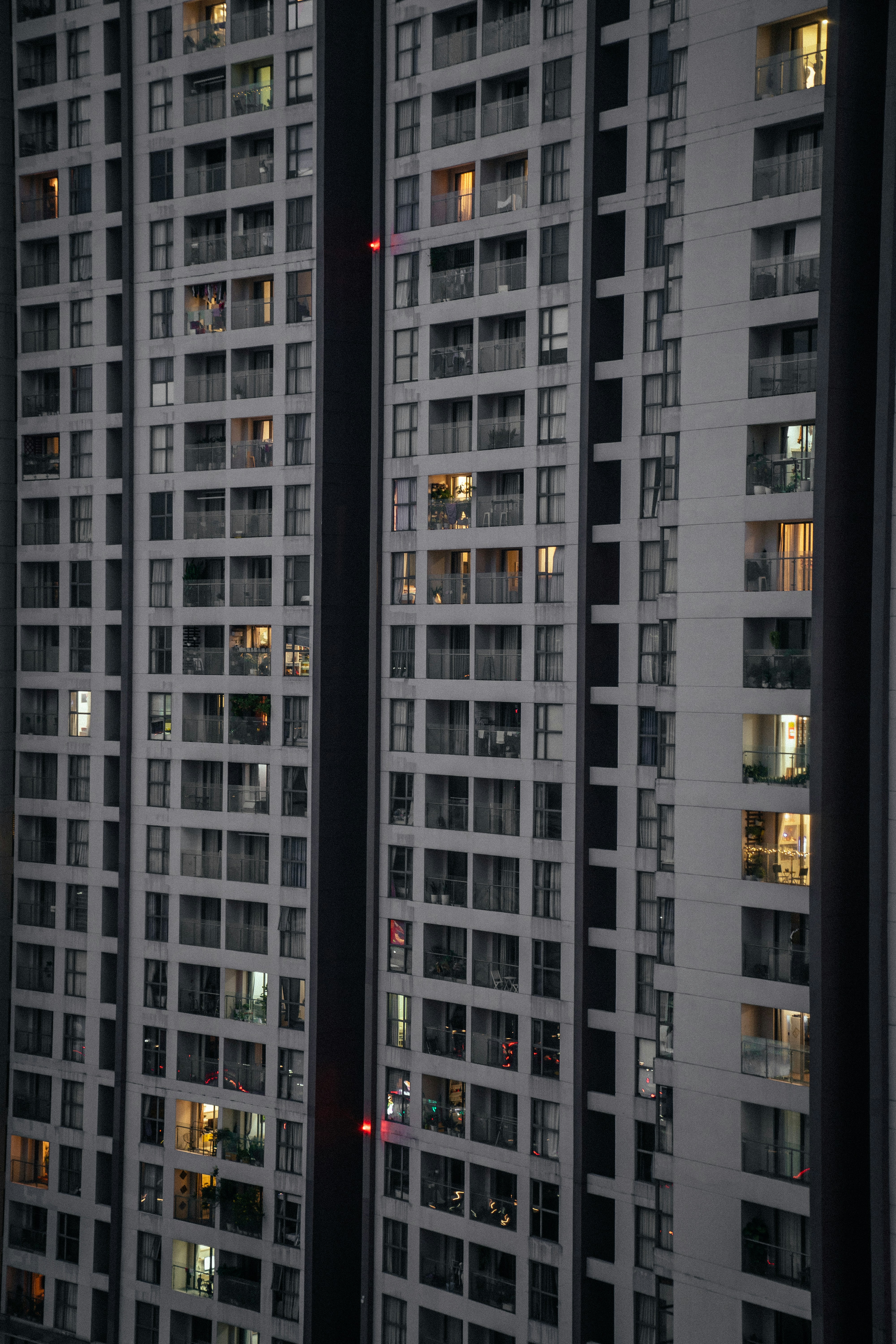 Un edificio muy alto con muchas ventanas por la noche