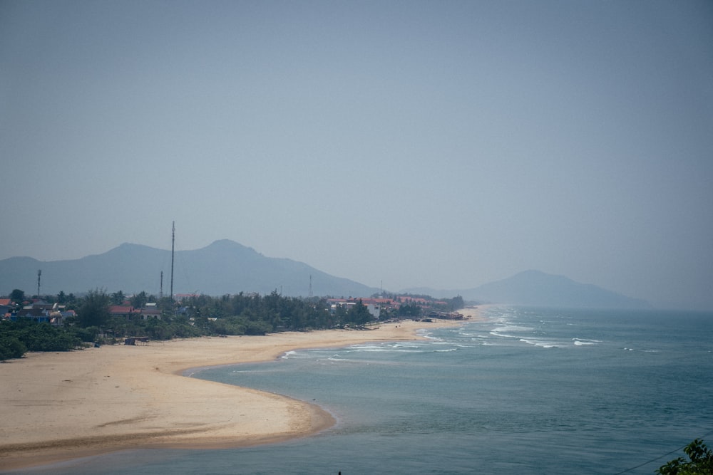 a view of a beach with mountains in the background