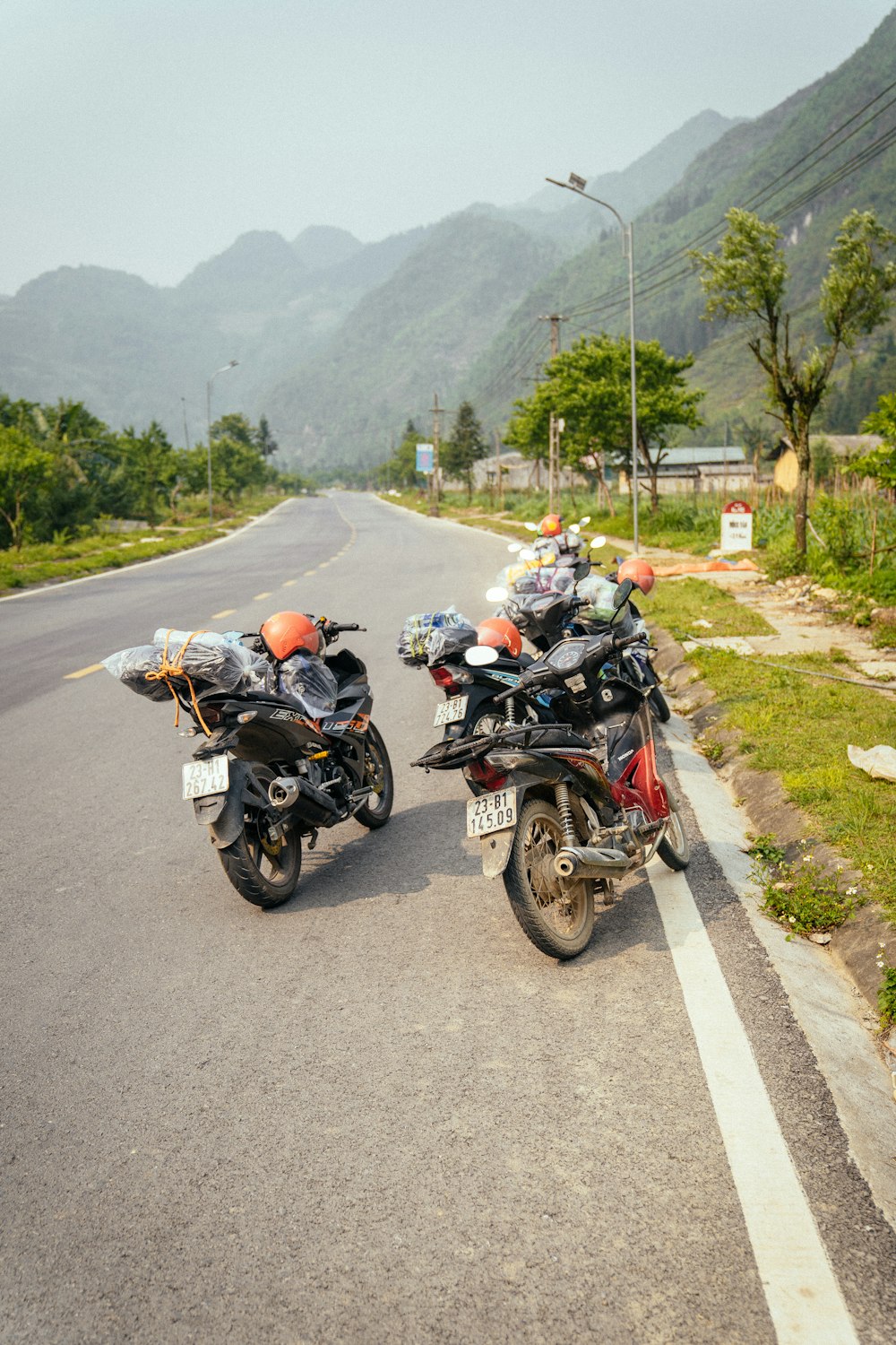 two motorcycles parked on the side of the road
