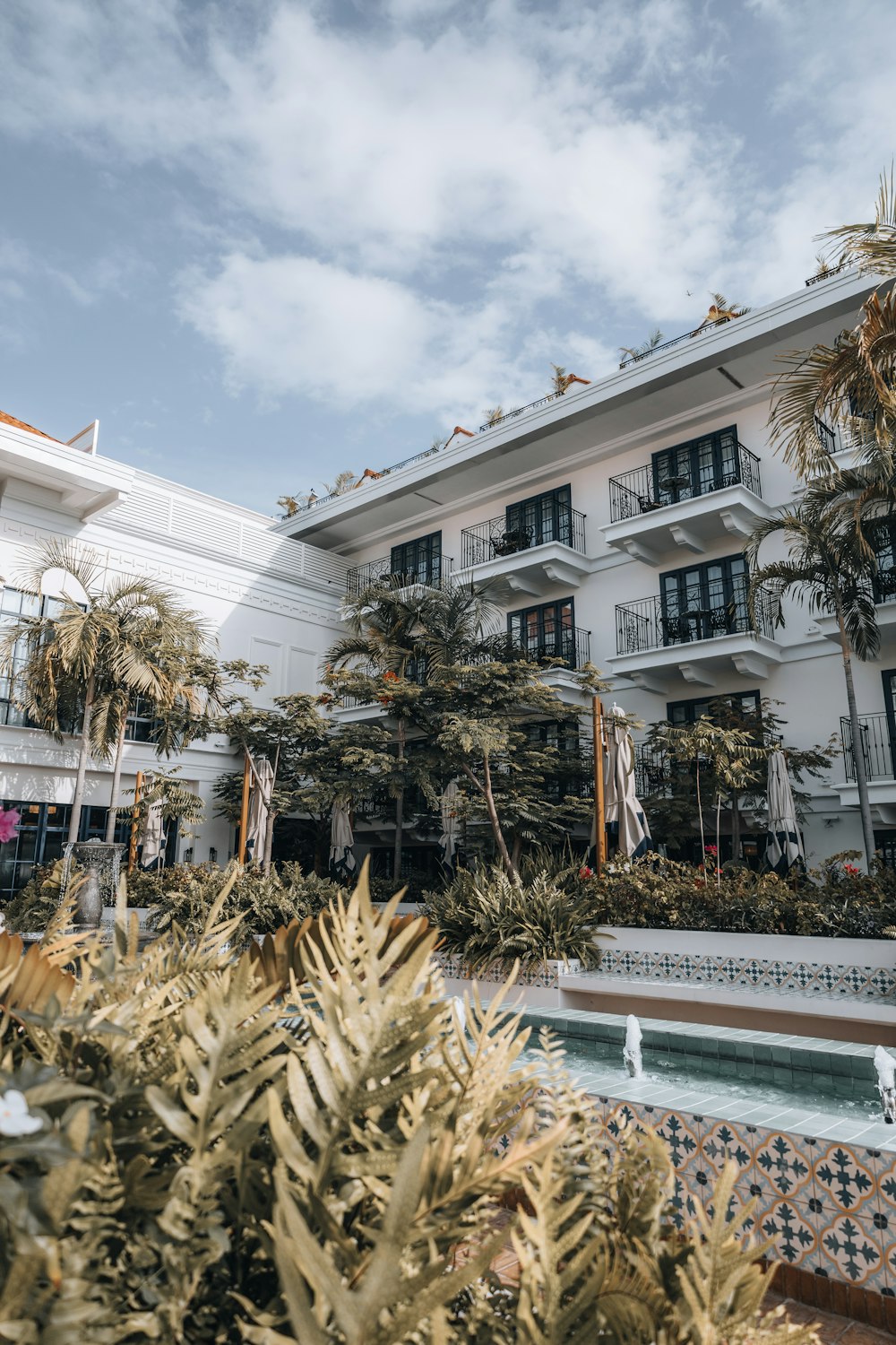 a hotel with a pool in front of it