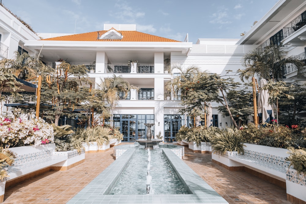 a large white building with a fountain in front of it