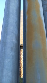 Close-up of reinforced concrete pillars being molded with steel bars inside.