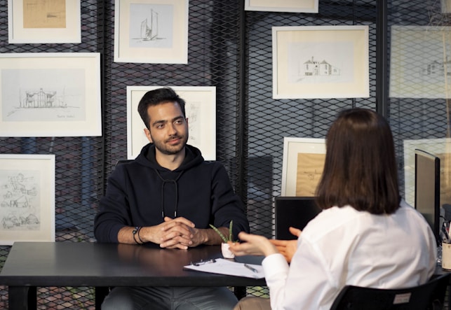 a recruiter and a woman sitting at a table