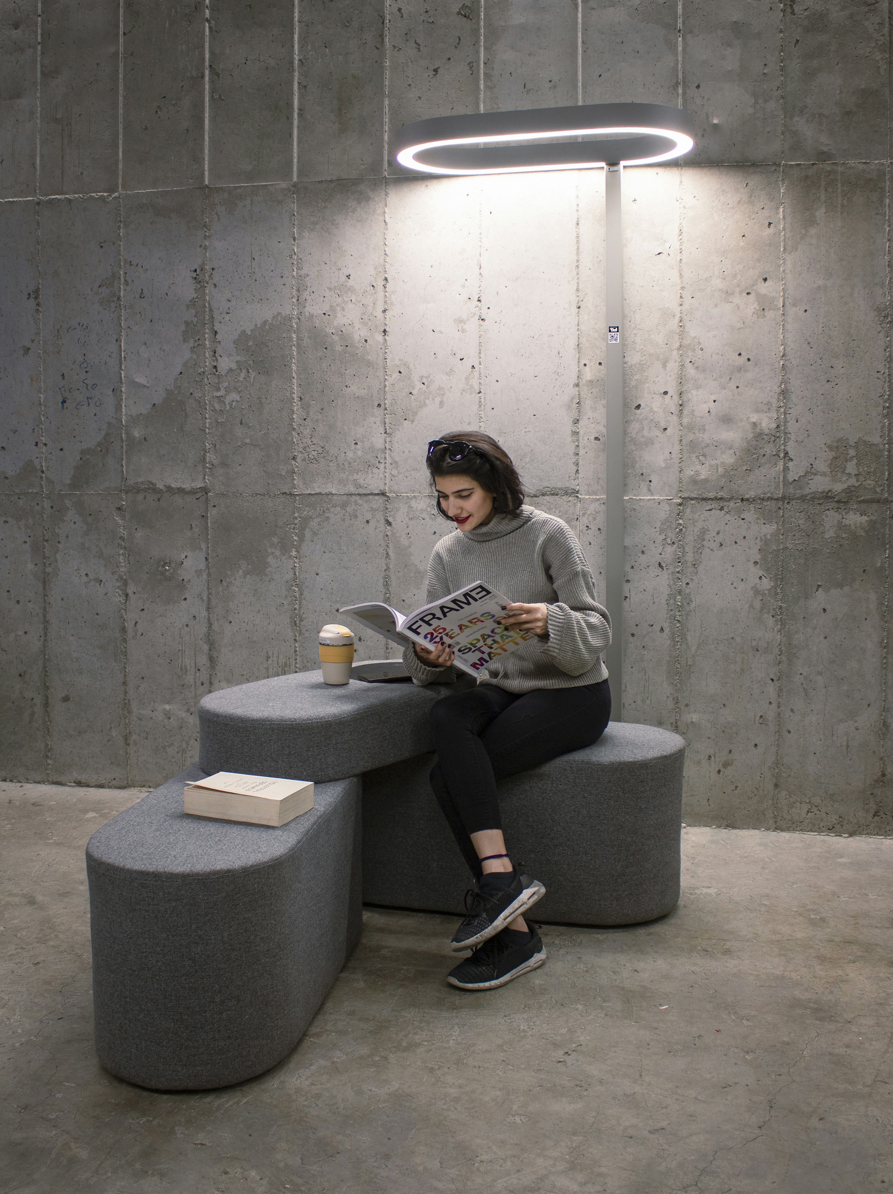 a woman sitting on a bench reading a book