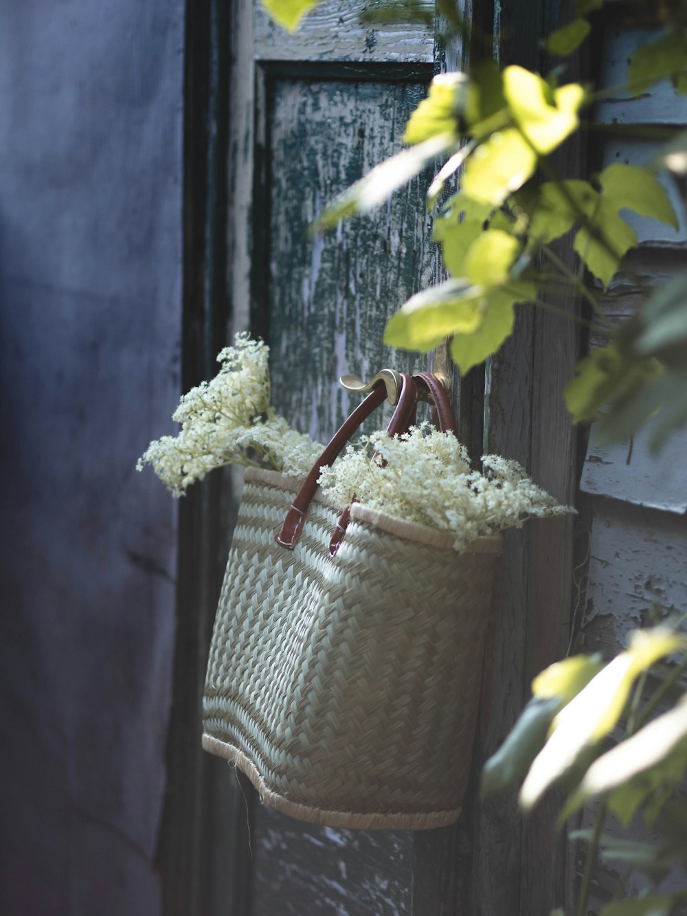 a wicker basket hanging from a door