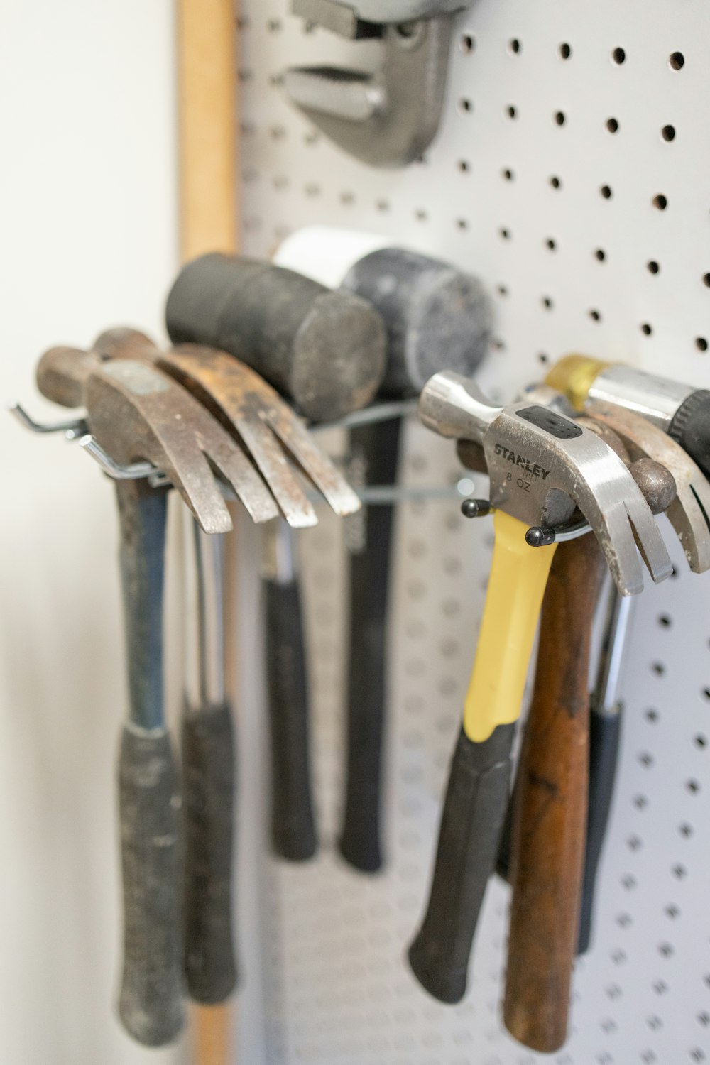 a bunch of tools hanging on a pegboard