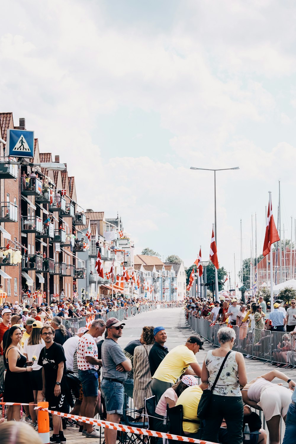 a crowd of people standing around a street