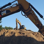a large pile of dirt sitting next to a bulldozer