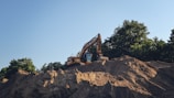 a bulldozer digging through a pile of dirt