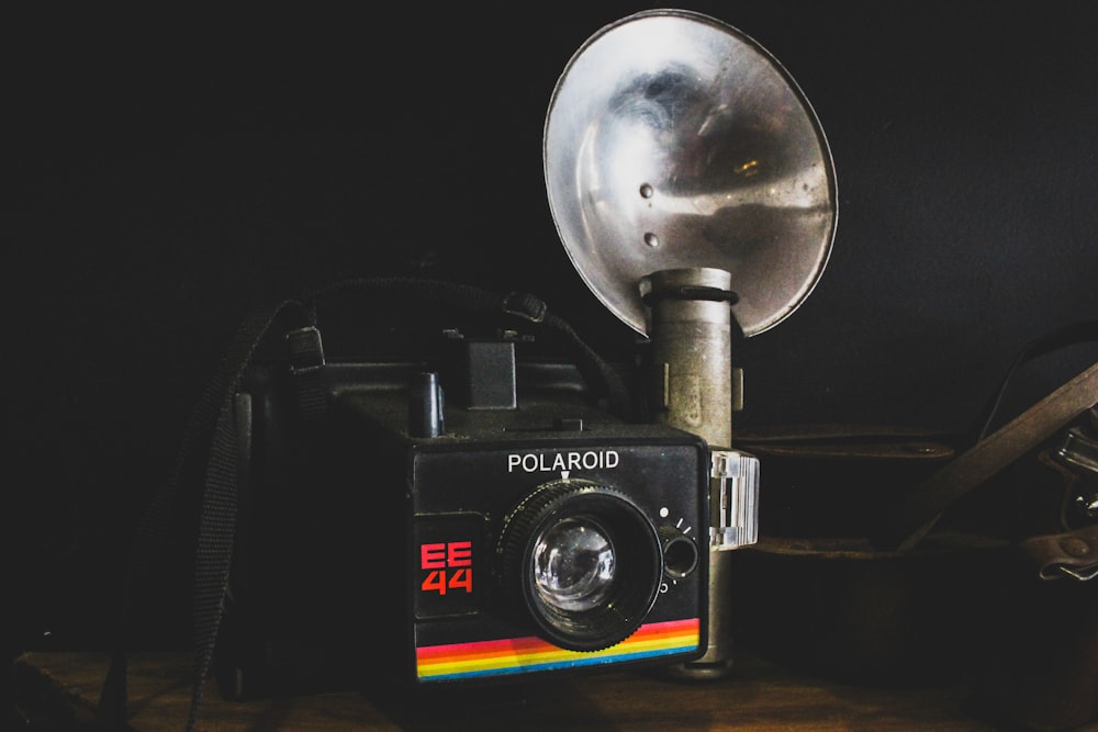 a polaroid camera sitting on top of a wooden table