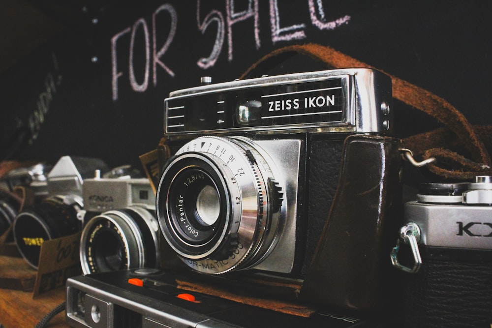 an old camera sitting on top of a wooden table