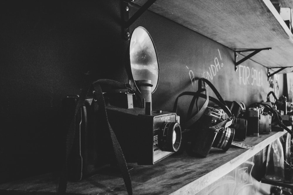 a black and white photo of a camera and a mirror