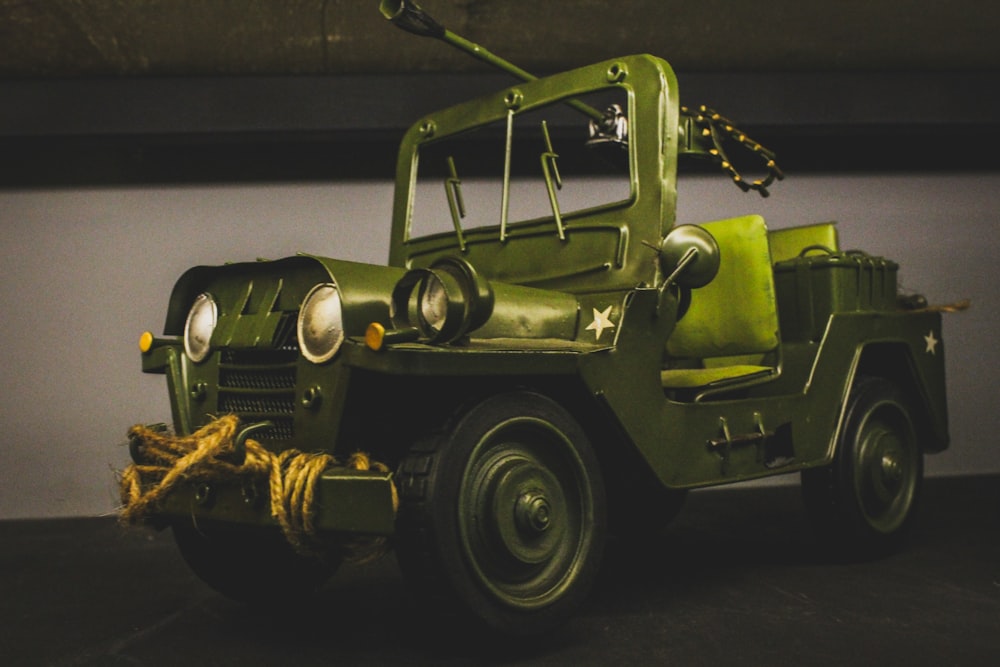 a green jeep with a rope on the front of it