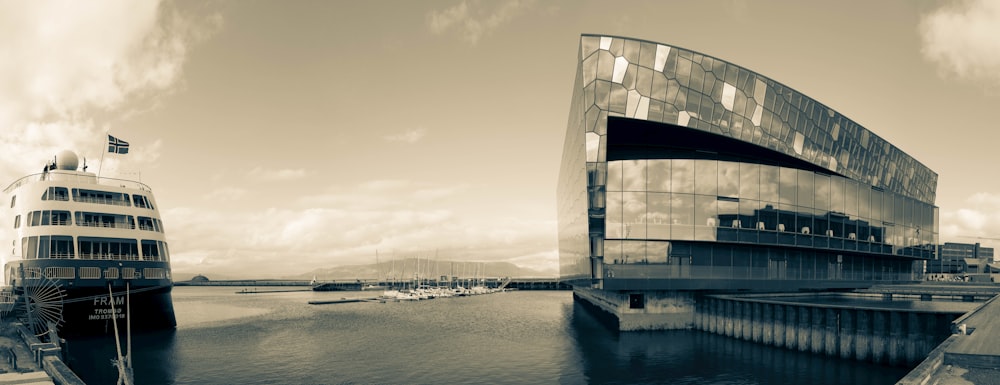 a black and white photo of a boat docked in a harbor